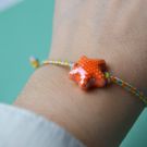 PULSERA HILO ESTRELLA NARANJA ONL