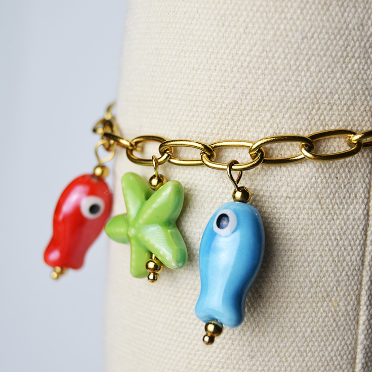 pulsera eslabones charm peces y estrella de mar